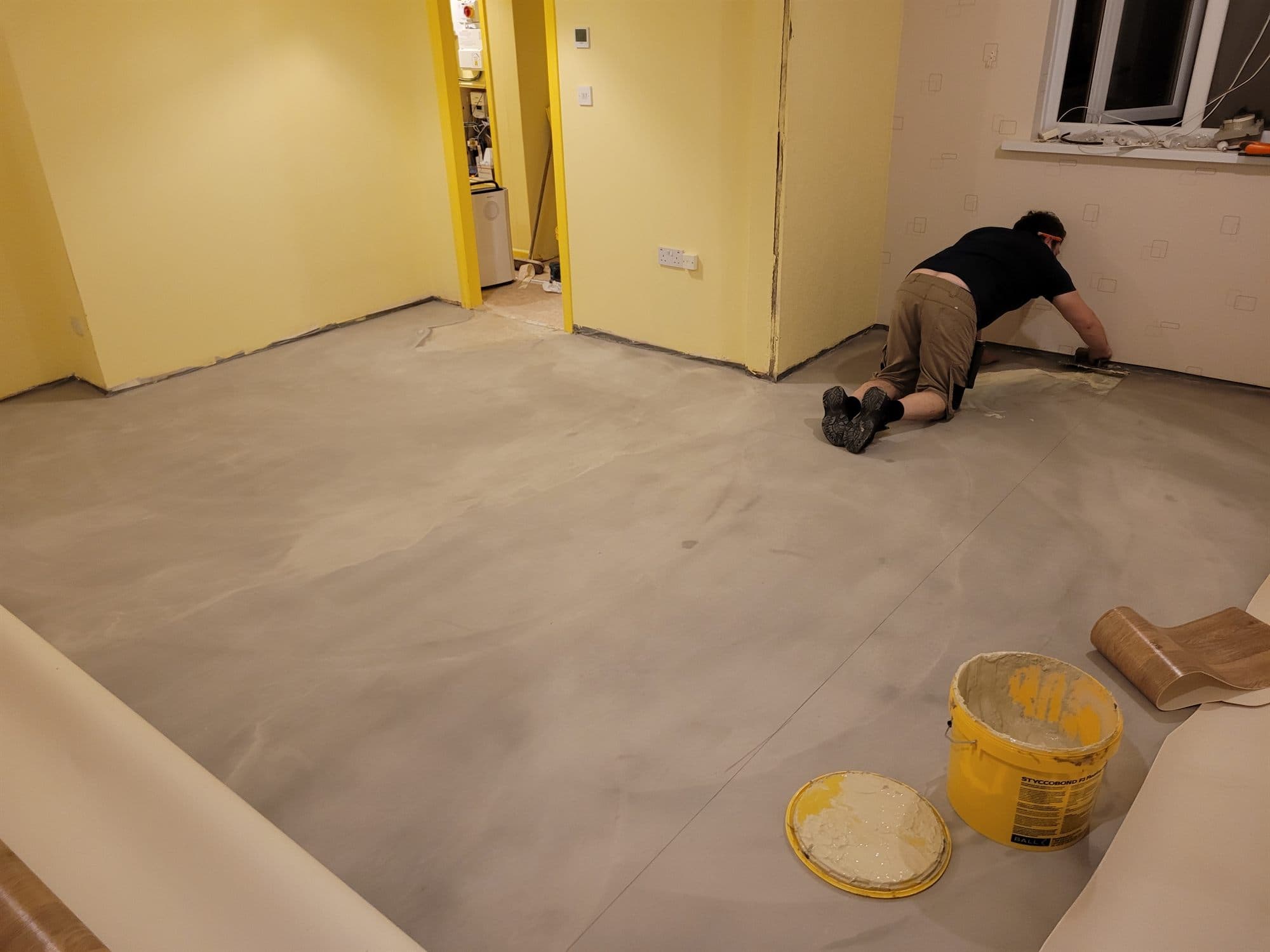 Levelling compound being applied to a floor before new flooring