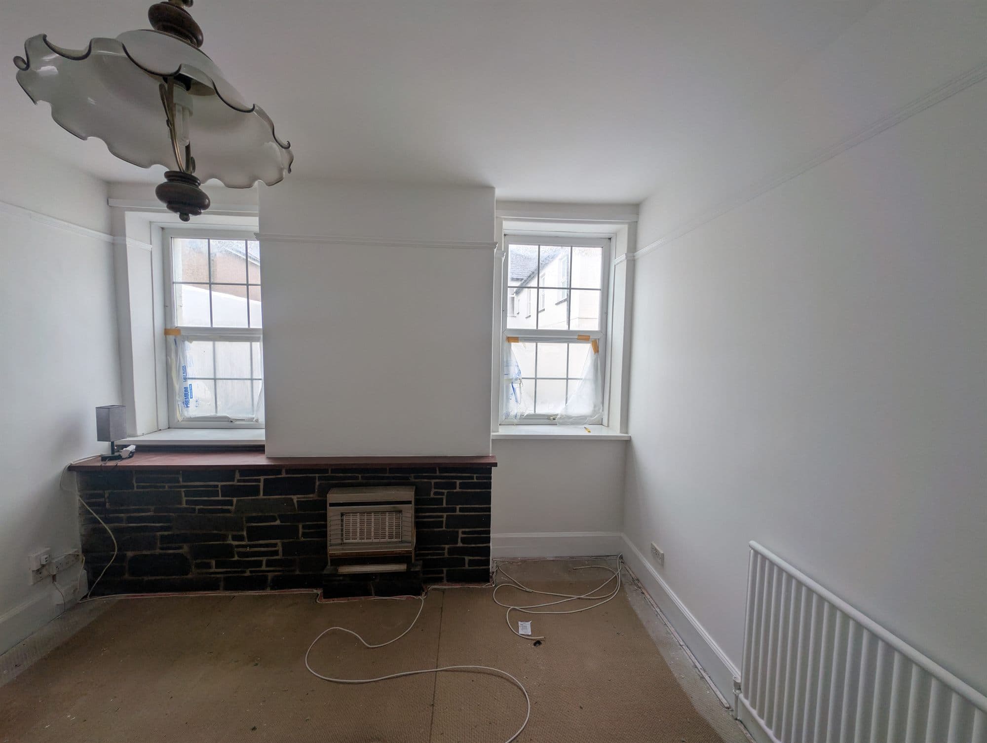 Same room redecorated around the chimney breast and slate fireplace surround