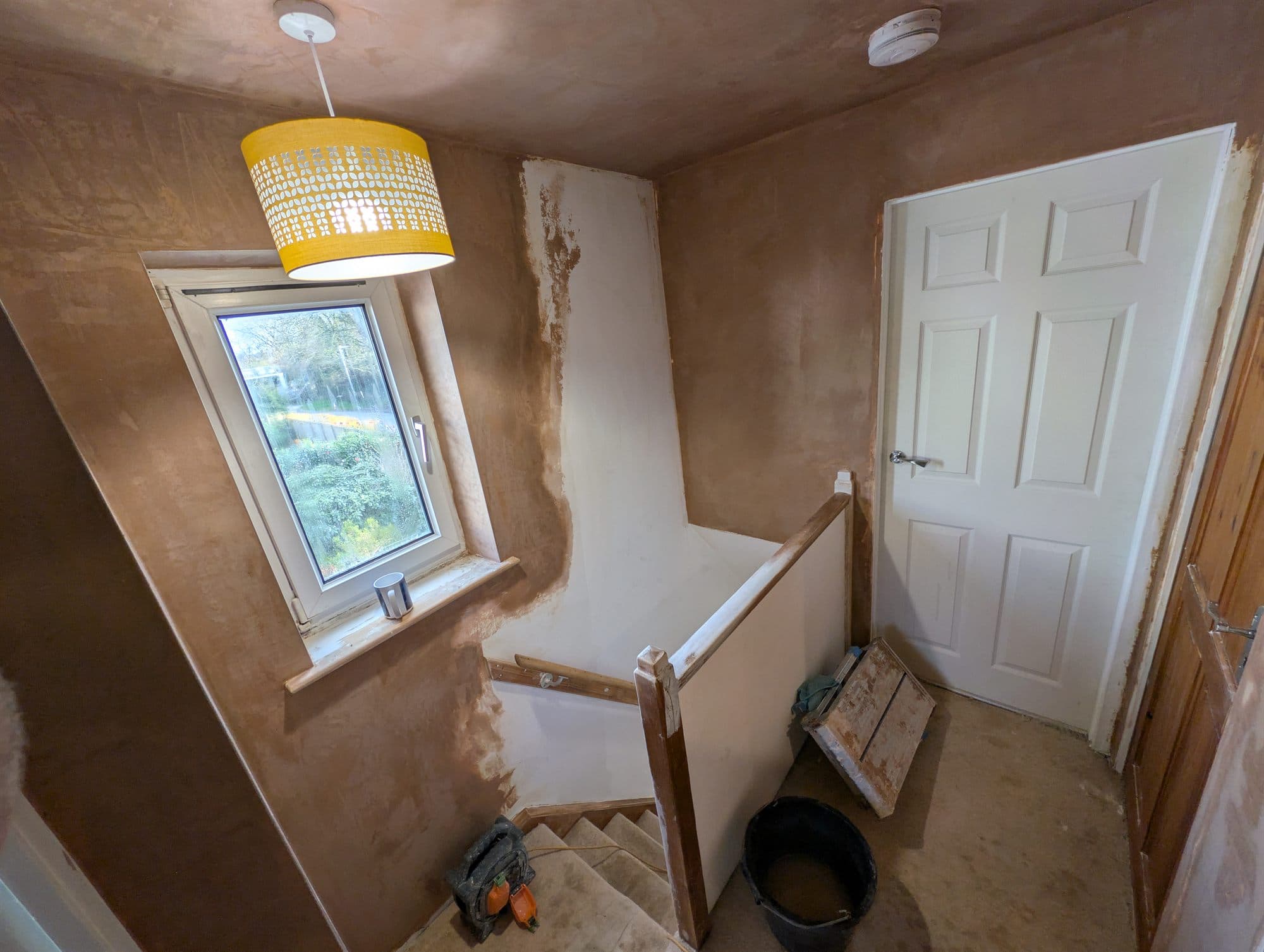 Landing and stairwell walls freshly plastered, before decorating