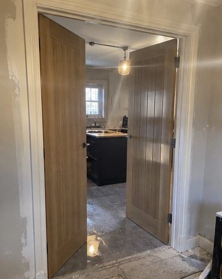 Pair of wooden cottage-style internal doors fitted into a doorway