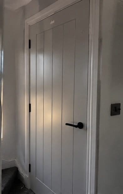 Painted grey cottage-style internal door with black handle