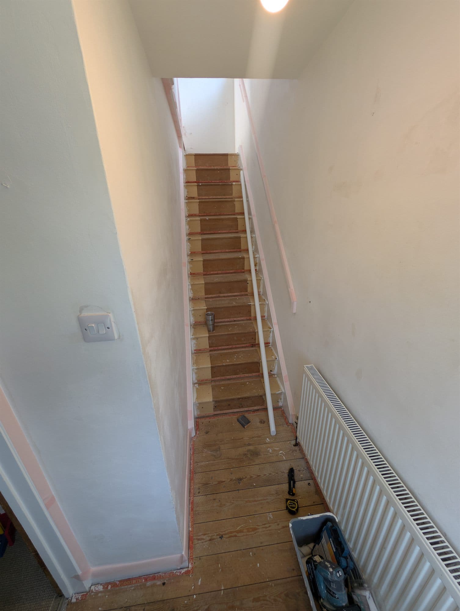 Staircase stripped back to bare treads with walls prepared for decorating