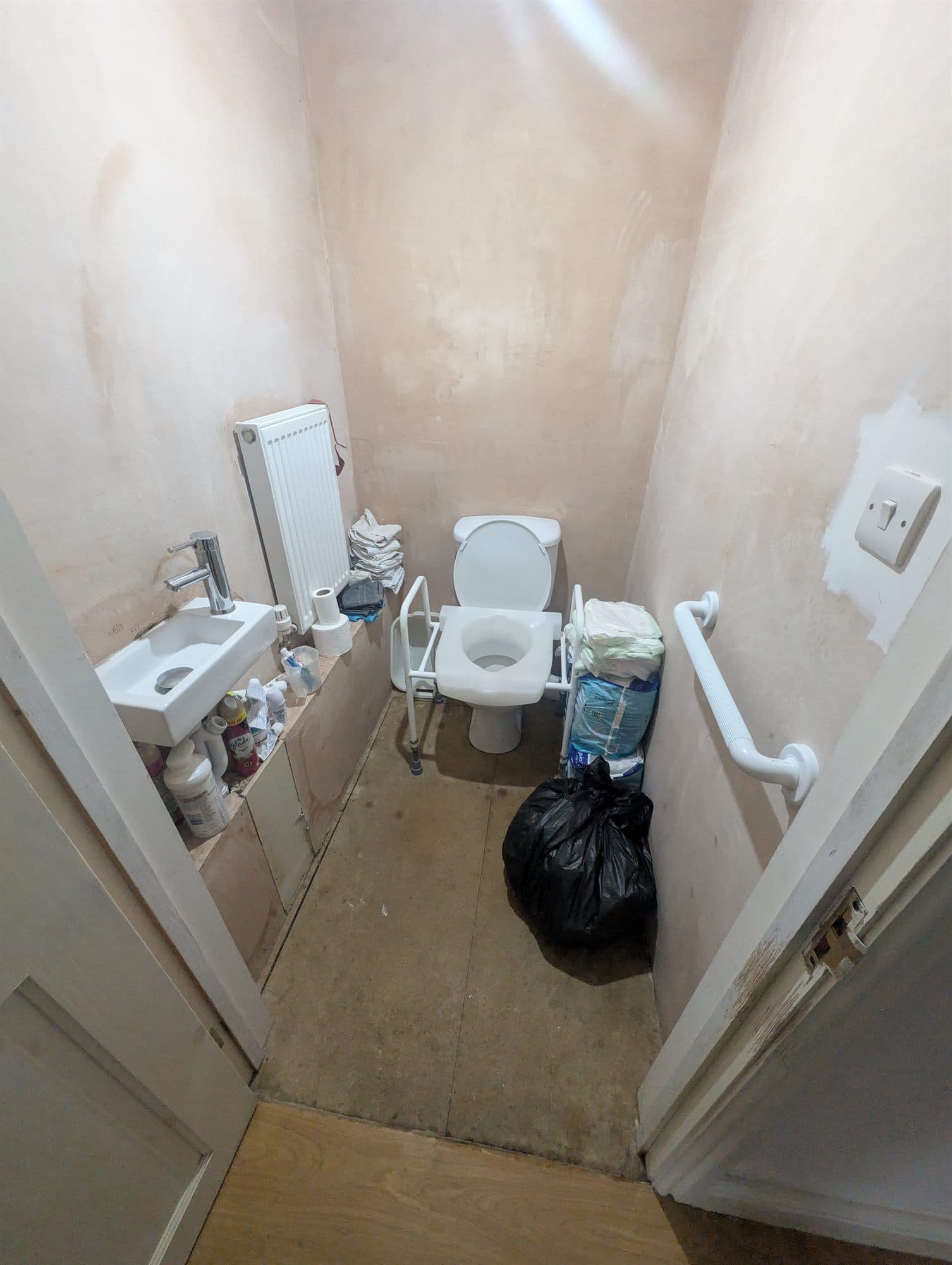 Small downstairs WC stripped back to bare plaster walls and floorboards before refurbishment